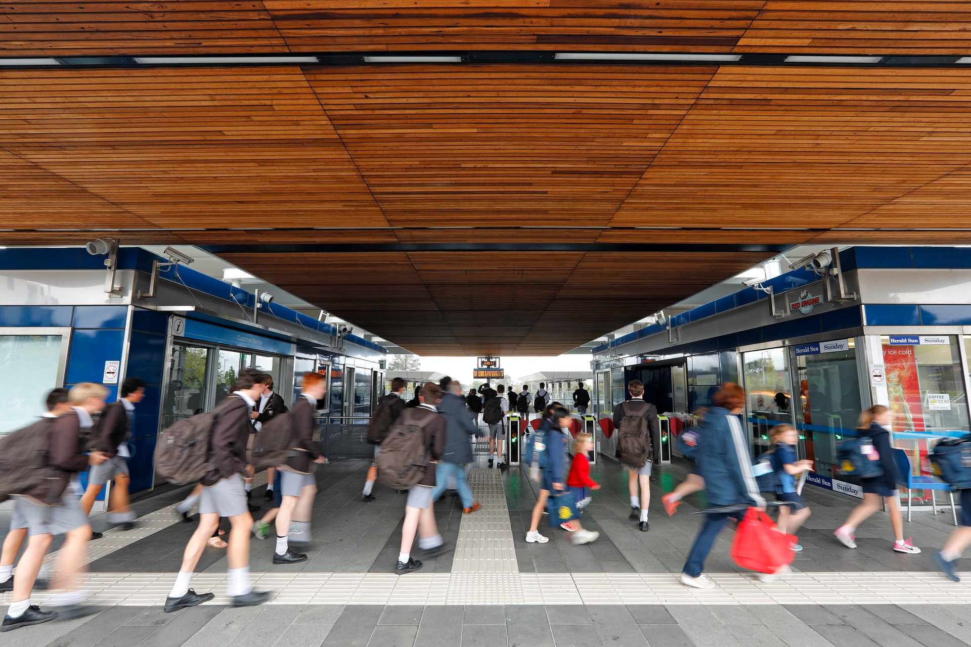 Mitcham station with people in foreground